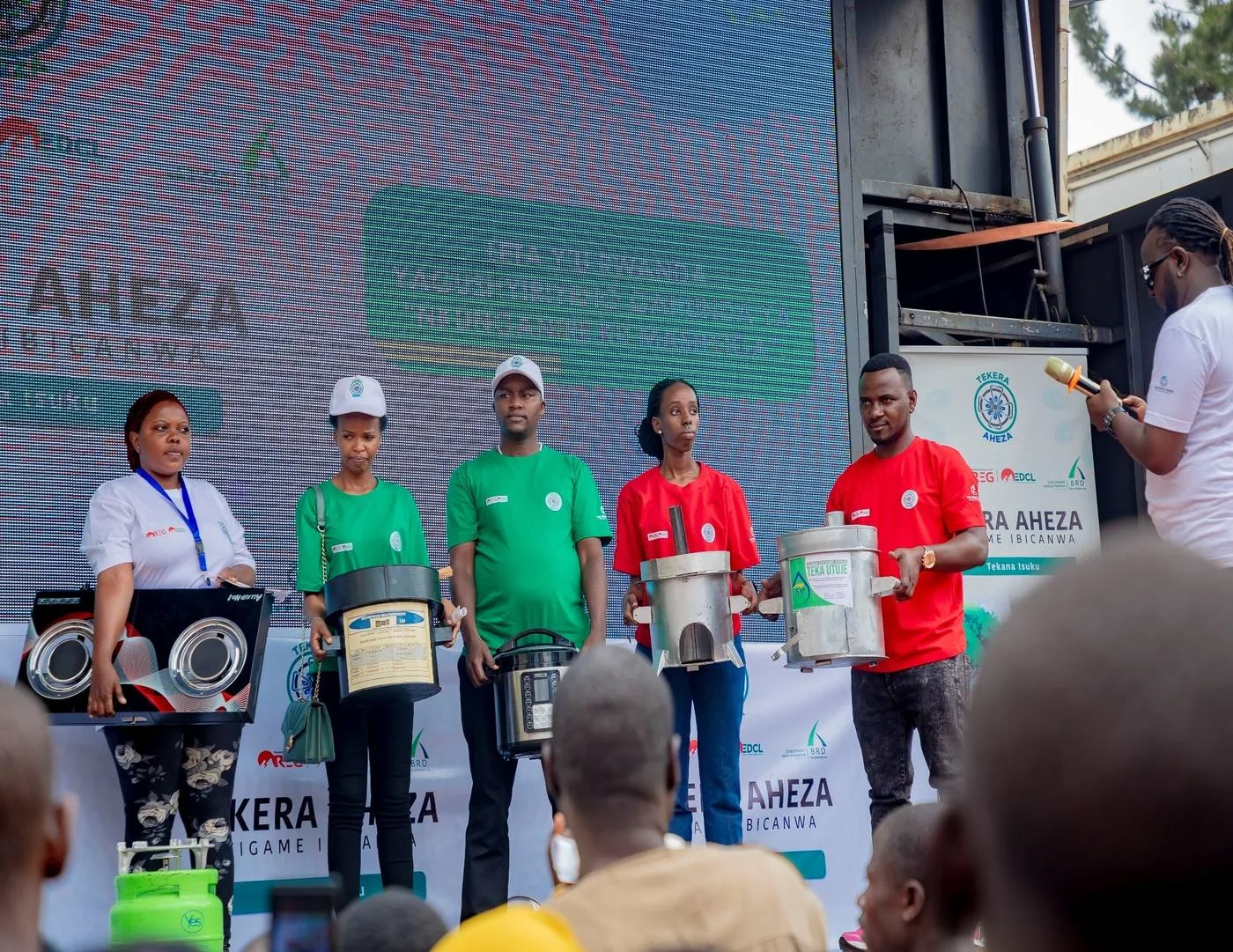 Improved cookstoves presented on stage at a clean cooking campaign event in Rwanda
